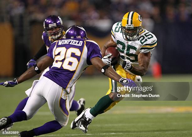 Running back Ryan Grant of the Green Bay Packers carries the ball against cornerback Antoine Winfield of the Minnesota Vikings on November 9, 2008 at...