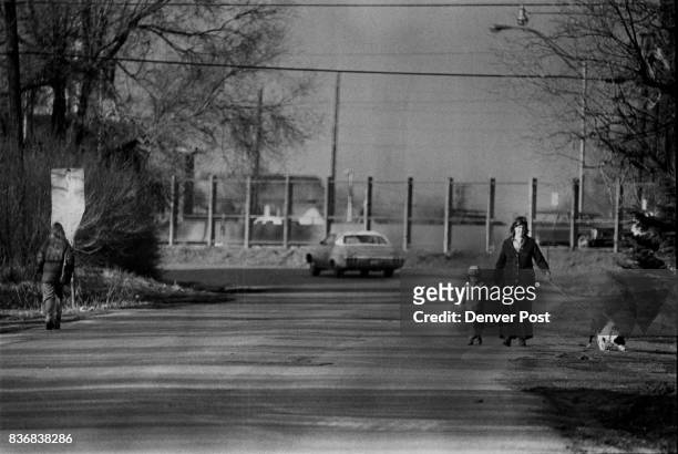 Highway 25 Sound Barrier Construction continues along Interstate 25 A woman walks with her child and dog near South Dahlia Street and Yale Avenue,...