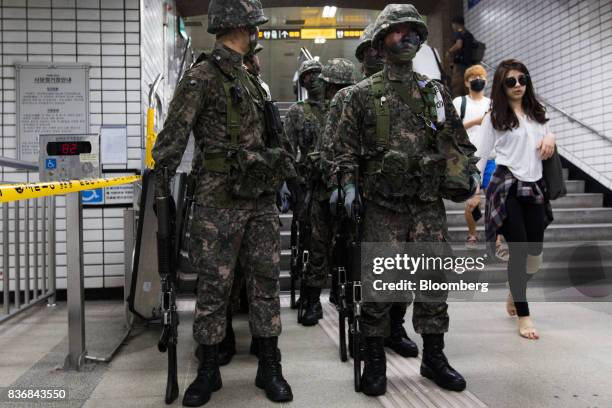 Soldiers stand guard during an anti-terror drill on the sidelines of the Ulchi Freedom Guardian military exercises at a subway station in Seoul,...