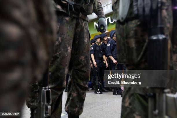 Police officers stand guard beyond soldiers during an anti-terror drill on the sidelines of the Ulchi Freedom Guardian military exercises at a subway...