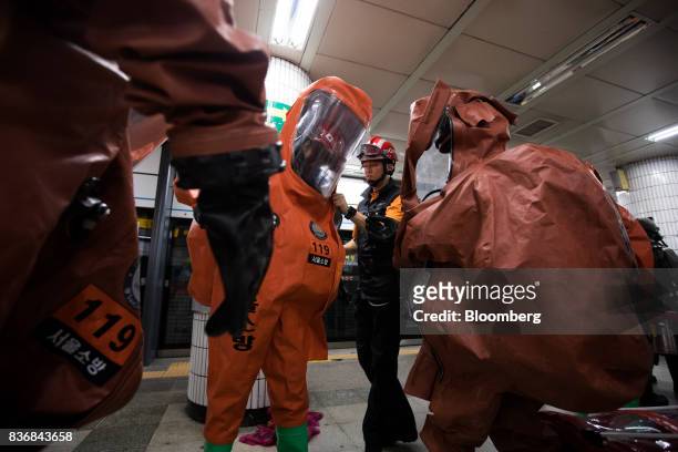 Firefighters wear protective clothing during an anti-terror drill on the sidelines of the Ulchi Freedom Guardian military exercises at a subway...