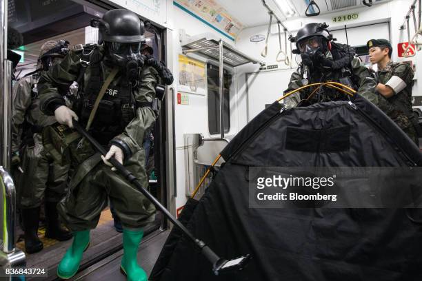 Soldiers wearing gas masks perform inspections inside a subway train during an anti-terror drill on the sidelines of the Ulchi Freedom Guardian...