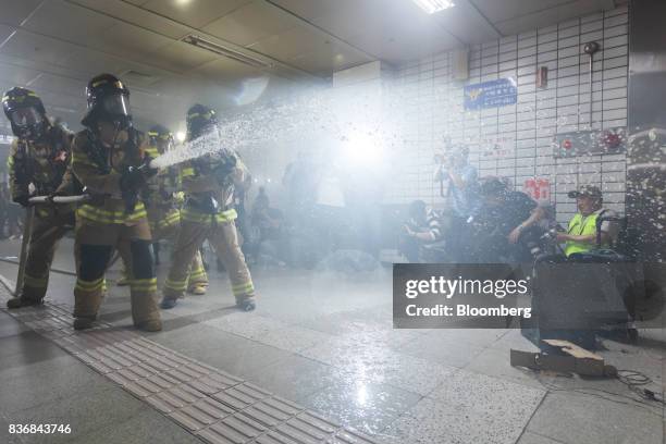 Firefighters spray their hose during an anti-terror drill on the sidelines of the Ulchi Freedom Guardian military exercises at a subway station in...