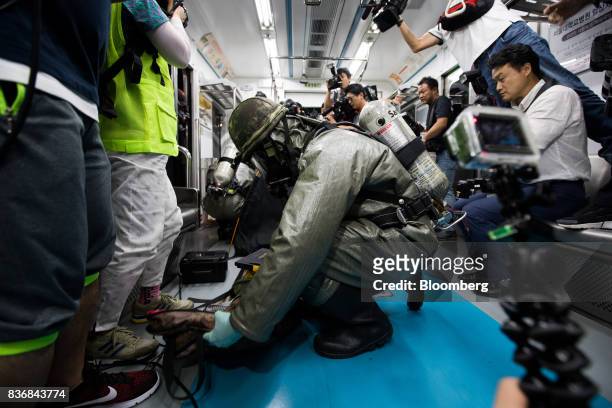 Soldiers wearing gas masks perform inspections inside a subway train during an anti-terror drill on the sidelines of the Ulchi Freedom Guardian...