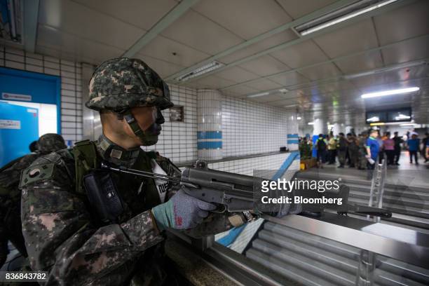 Soldier stands guard during an anti-terror drill on the sidelines of the Ulchi Freedom Guardian military exercises at a subway station in Seoul,...