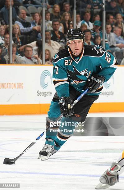 Jeremy Roenick of the San Jose Sharks tries to maneuver the puck down the ice during an NHL game against the Calgary Flames on November 13, 2008 at...