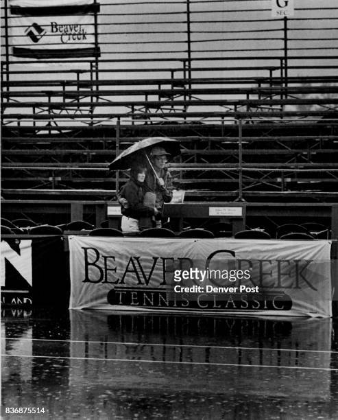 Tennis Glen and Sandy Hartmann of Glenwood Springs wait out the rain at Beaver Creek. Credit: The Denver Post