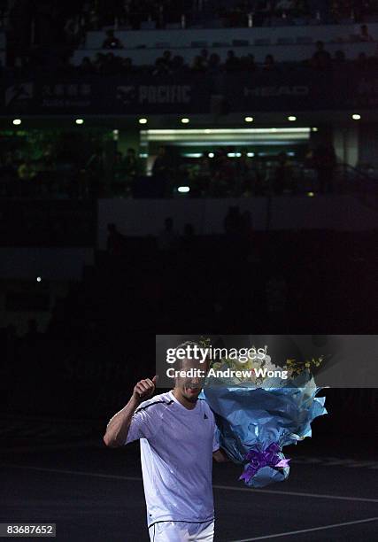 Jonas Bjorkman of Sweden acknowledges the crowd during a ceremony to announce his retirement after his last double match in the Tennis Masters Cup...