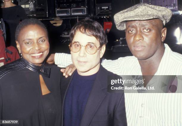 Singer Miriam Makeba, musician Paul Simon and Bonagni Holphe attend the party for "Asinamali" on April 23, 1987 at Stringfellow's in New York City.