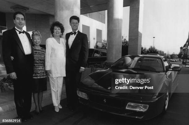 From left, Paul Brooks, Janice DeTemple, Irene Zarlengo and Denver post publisher Ryan McKibben pose for a snap with a Ferrari in front of Loews...