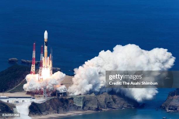In this aerial image, the H-IIA Launch Vehicle No.35 lifts off from the launch pad at the Japan Aerospace Exploration Agency Takegashima Space Center...