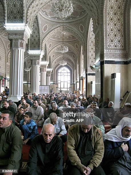Iraqi Sunni Muslims sit listening to the Friday noon sermon at the Abu Hanifa mosques in the Adhamiyah district of northern Baghdad on November 14,...