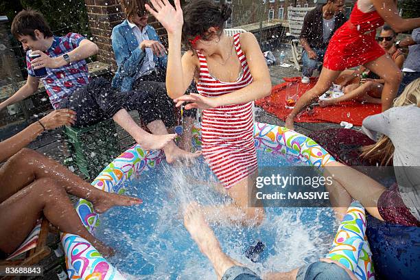 people splashing in kiddie pool - paddling pool stock pictures, royalty-free photos & images