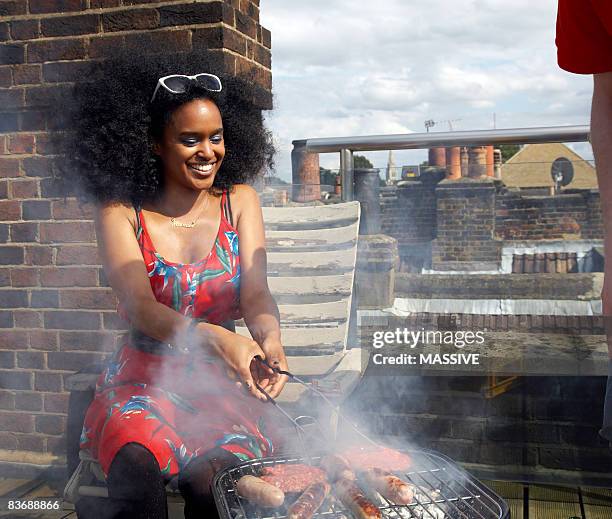 girl flips burgers on the barbecue - woman cooking stock pictures, royalty-free photos & images
