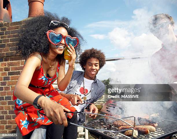 group of friends at barbecue - burger on grill photos et images de collection