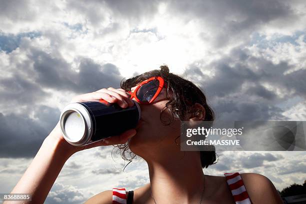 girl drinking from a can - blik stockfoto's en -beelden