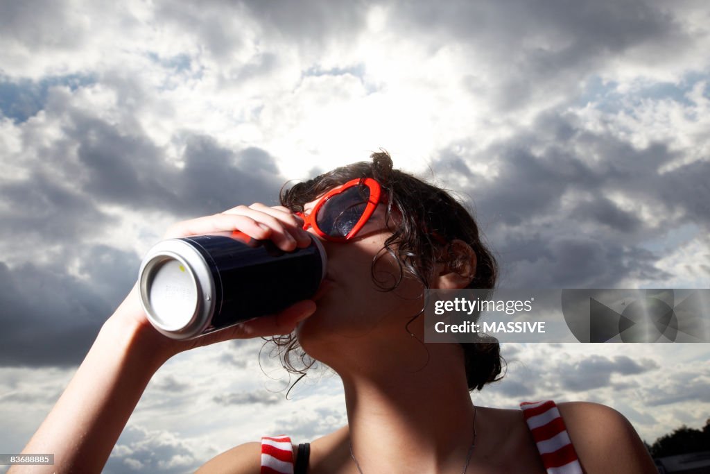 Girl drinking from a can