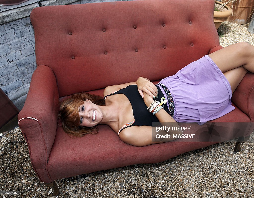 Girl lying on sofa, smiling
