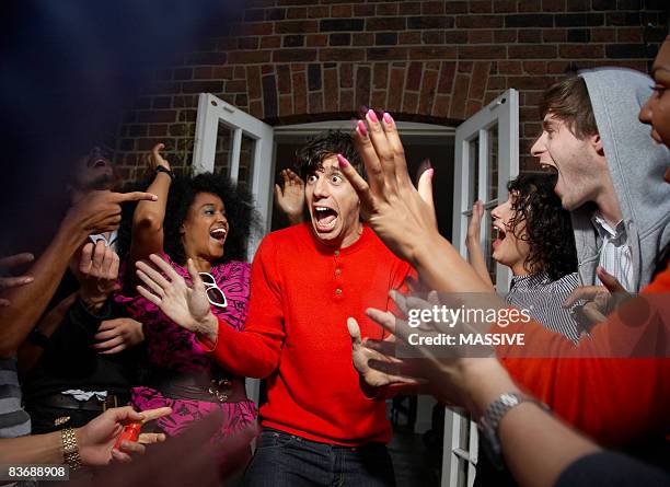 man being surprised by his friends - party hat stock-fotos und bilder