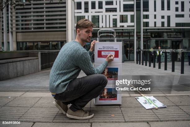 John Tyson, the founder of a petition to bring in fire safety regulations to make Britain's tower blocks safer, poses for a photograph before handing...