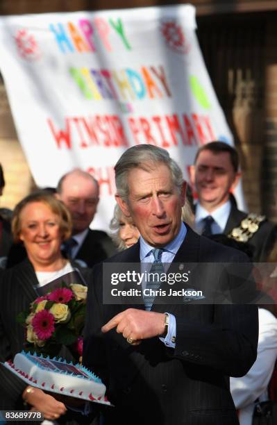 Prince Charles, Prince of Wales holds a birthday cake he was given as he visits Beckton Community Centre as part of the launch of The Prince's Trust...