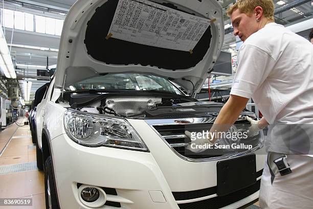 Worker assembles a VW Tiguan at the Volkswagen car factory on November 14, 2008 in Wolfsburg, Germany. Many European carmakers are tightening their...