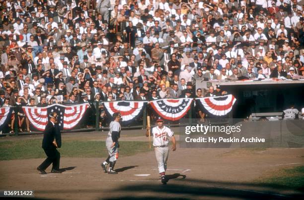 Eddie Mathews of the Milwaukee Braves walks around the batter's box as catcher Yogi Berra of the New York Yankees looks on during Game 5 of the 1957...