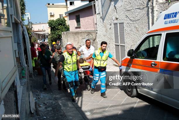 Italian emergency workers evacuate on a stretcher Mattias, a 7-year-old boy who was trapped by rubble, in Casamicciola Terme, on the Italian island...