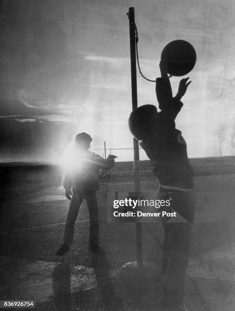 Game Continues to the End Two youngsters take advantage of the last rays of sunshine on a recent sunny day to play a game of tetherball on the...
