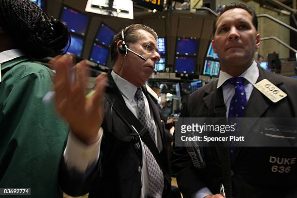 Traders work on the floor during morning trading at the New York Stock Exchange November 14, 2008 in New York City. The Dow was down over 200 points...