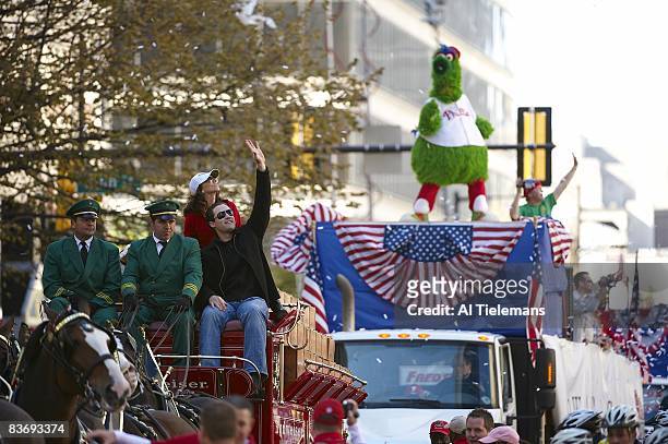 World Series: Philadelphia Phillies Pat Burrell aboard Budweiser wagon during Victory Parade on Market Street. View of Phillie Phanatic mascot....
