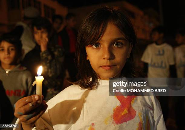 Palestinian girl holds a candle during a demonstration in Gaza City on November 14 against the Isreali blockade on the territory. Violence flared...