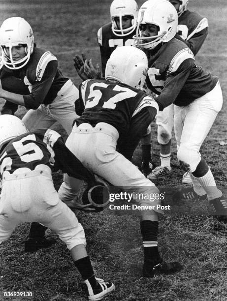 Billy, playing defensive center, watches snap of ball. Credit: Denver Post