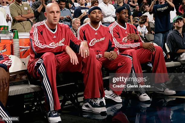 Zydrunas Ilgauskas, Mo Williams and LeBron James of the Cleveland Cavaliers sit on the bench before the game against the Dallas Mavericks on November...