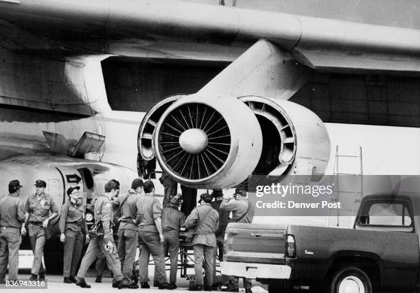 Air Force mechanics replace a faulty oil-pressure gauge on one of two C-141 cargo planes used to transfer Weteyes The faulty gauge caused the plane...