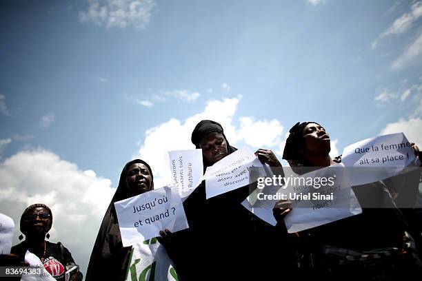 Congolese Women hold signs with words in french as they rally in protest of the conflict and violence in the region on November 14, 2008 in Goma,...