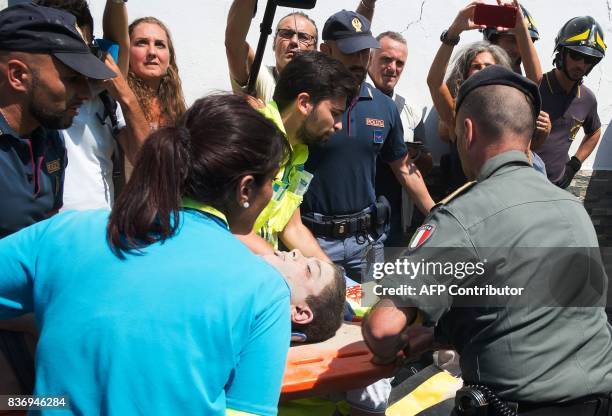 Italian emergency workers evacuate, on a stretcher, Ciro, a 11 year-old boy who was trapped by rubble, in Casamicciola Terme, on the Italian island...