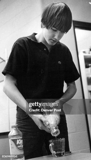 Let's see, how much corn syrup? Steven Sheppard pours in boy's personal survival class at Issac Newton Junior High School. Credit: Denver Post