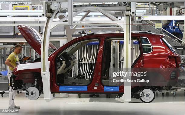 Worker assembles a VW Golf at the Volkswagen car factory on November 14, 2008 in Wolfsburg, Germany. Many European carmakers are tightening their...
