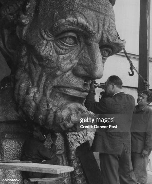 Sculptor Puts Finishing Touches to Lincoln Bust Robert Russian, faculty member at the University of Wyoming , shows Mexican foundry worker how he...