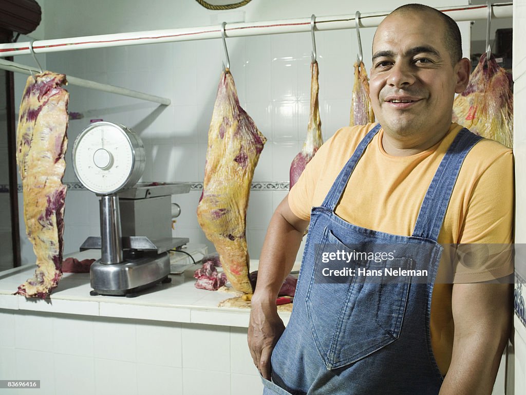 Butcher standing in front of counter