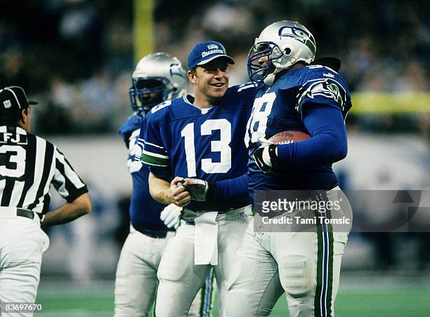 Seattle Seahawks quarterback Glenn Foley congratulates defensive tackle Sam Adams during a 26-16 victory over the Buffalo Bills on October 24 at the...