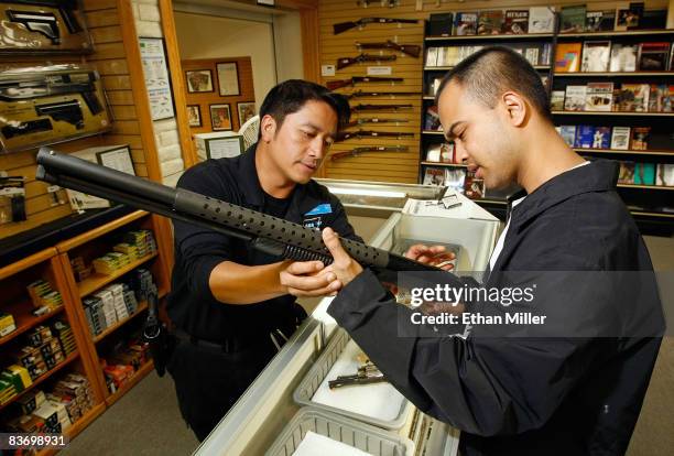 The Gun Store rangemaster Heu Thao shows Mark Torio of Nevada a shotgun November 14, 2008 in Las Vegas, Nevada. Store manager Cliff Wilson said he's...