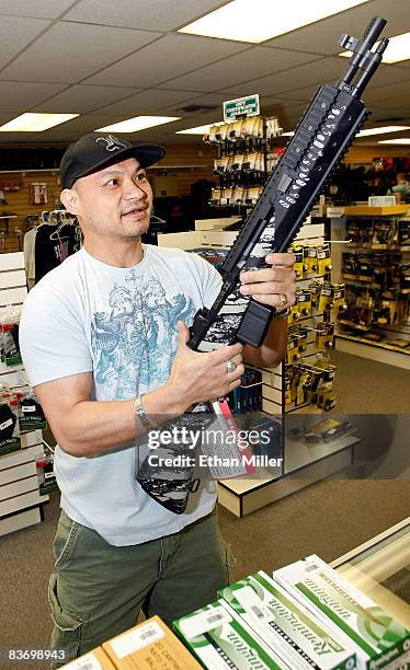 Won Kim of Nevada examines a rifle at The Gun Store November 14, 2008 in Las Vegas, Nevada. Store manager Cliff Wilson said he's seen a large spike...