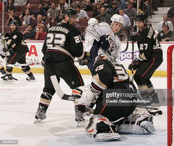 Kevin Klein of the Nashville Predators attempts a shot on goal as Jean-Sebastien Giguere, Francois Beauchemin, Scott Niedermayer of the Anaheim Ducks...