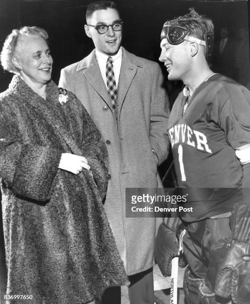 Pioneer Goalie-Rodney Schneck receives pre-game well wishes from Mrs. Chester M. Alter, wife of Denver University's chancellor and her son, Dick, a...