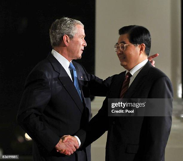 President George W. Bush welcomes President Hu Jintao of China to a summit on financial markets and the world economy on the North Portico of the...