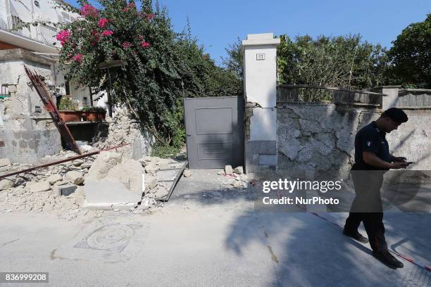 Police member walks near an house, destroyed in the earthquake in one of the more heavily damaged areas on August 22, 2017 in Casamicciola Terme,...