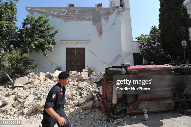 Police member walks near an house, destroyed in the earthquake in one of the more heavily damaged areas on August 22, 2017 in Casamicciola Terme,...