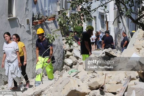 Rescuers teams walk near a damaged building in one of the more heavily damaged areas on August 22, 2017 in Casamicciola Terme, Italy. A magnitude-4.0...